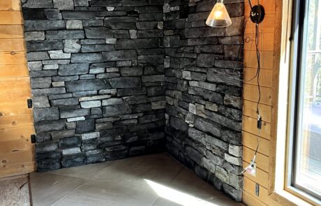 Waterman Construction custom fireplace surround with various colors of grey brick.