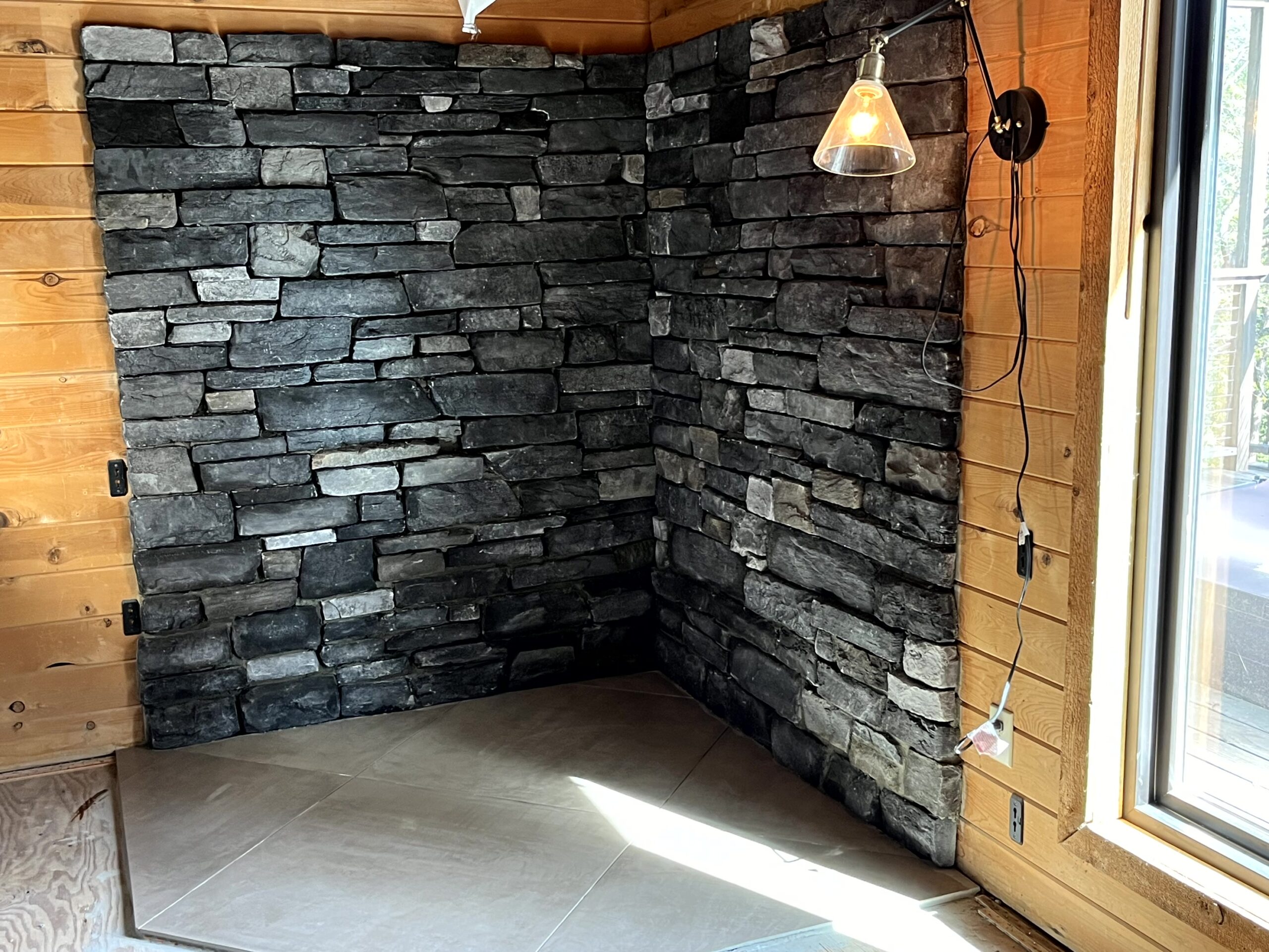 Waterman-Construction-Custom Waterman Construction custom fireplace surround with various colors of grey brick.