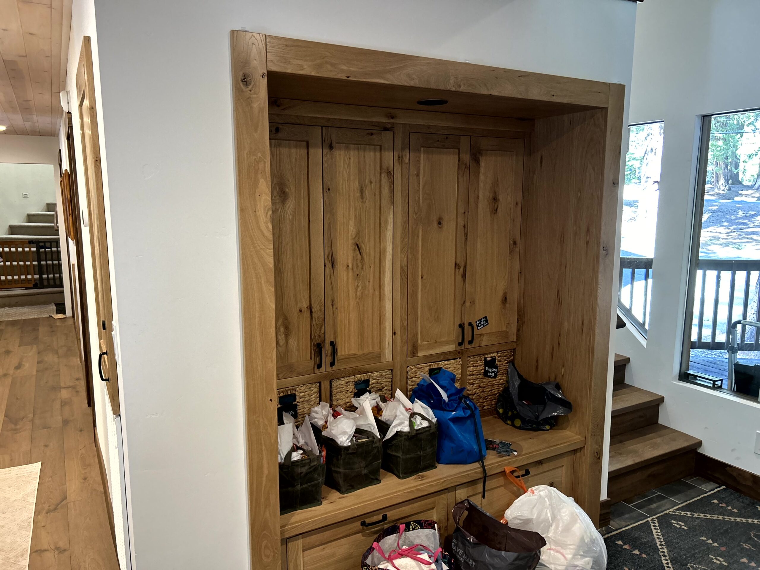 Waterman-Construction-Custom Waterman Construction custom addition of a built-in wooden entry storage area.