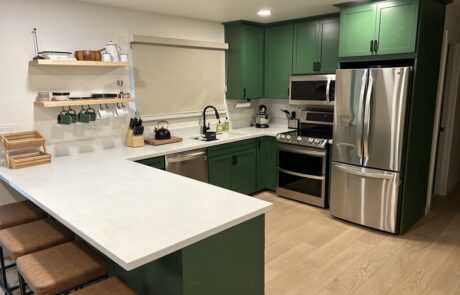Waterman Construction kitchen with green cabinets.