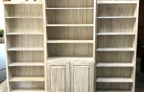 Waterman Construction custom wood bookcase with three pieces, and cabinets on the bottom of middle piece.